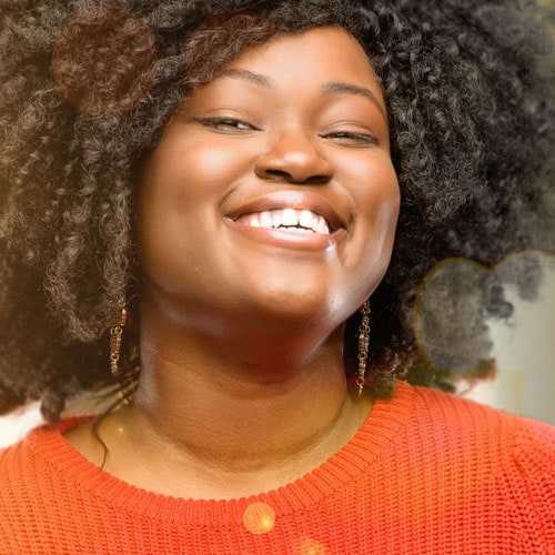 Portrait of Black Lady Smiling at the Camera Wearing a Red Jumper